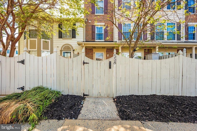 558 Hollyberry Way, Frederick, MD 21703 - view of home's exterior with brick siding, fence, and a gate