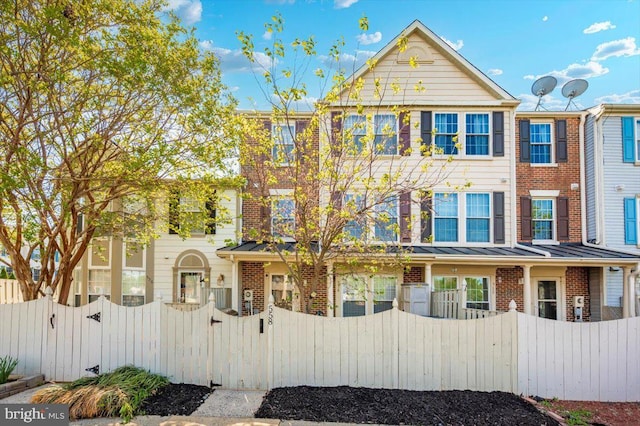 558 Hollyberry Way, Frederick, MD 21703 - multi unit property with brick siding, a gate, and a fenced front yard