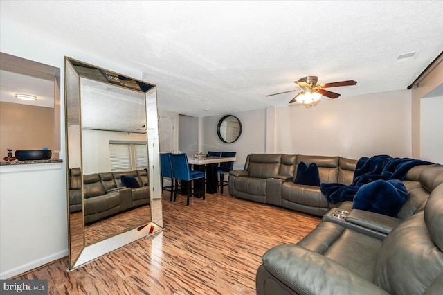 558 Hollyberry Way, Frederick, MD 21703 - living room with visible vents, wood finished floors, baseboards, a textured ceiling, and a ceiling fan