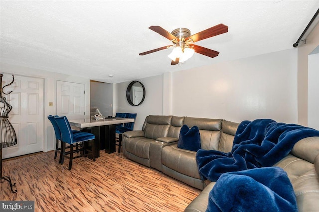 558 Hollyberry Way, Frederick, MD 21703 - living area with a ceiling fan, light wood finished floors, and a textured ceiling