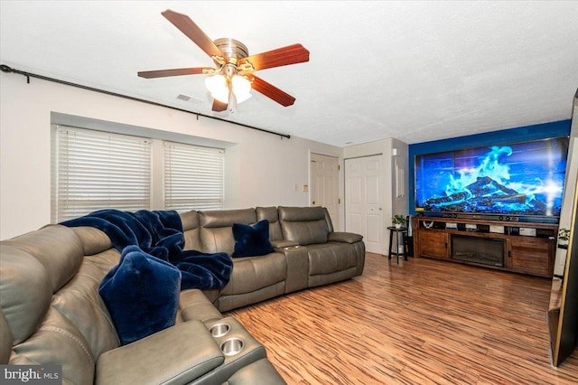 558 Hollyberry Way, Frederick, MD 21703 - living room with a textured ceiling, a ceiling fan, wood finished floors, and visible vents