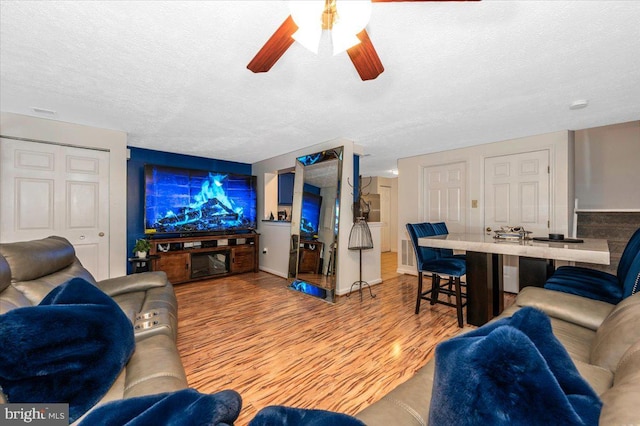 558 Hollyberry Way, Frederick, MD 21703 - living room with light wood-style floors, ceiling fan, and a textured ceiling