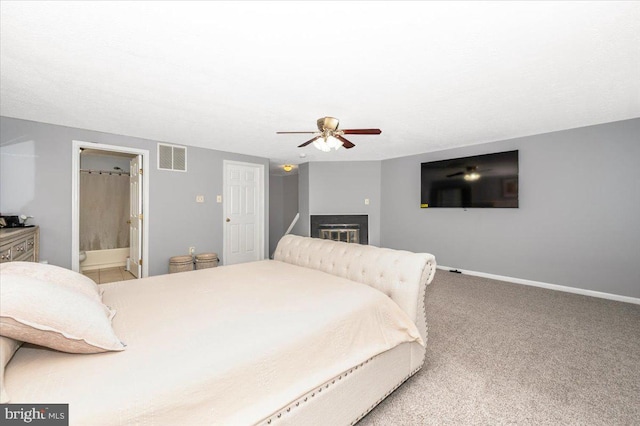 558 Hollyberry Way, Frederick, MD 21703 - carpeted bedroom with visible vents, baseboards, a glass covered fireplace, and ceiling fan