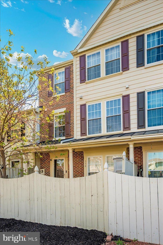 558 Hollyberry Way, Frederick, MD 21703 - view of home's exterior with brick siding and fence