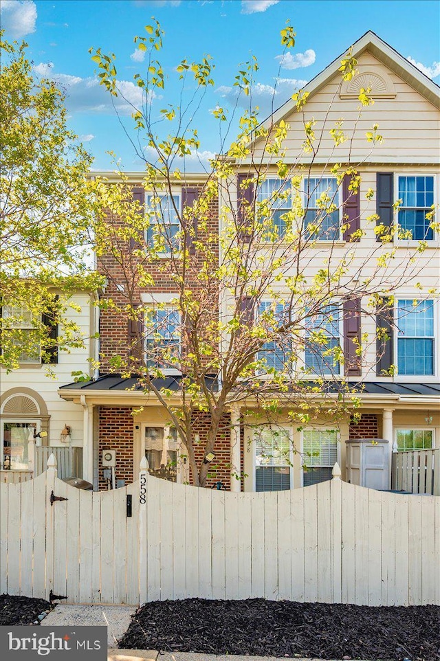 558 Hollyberry Way, Frederick, MD 21703 - multi unit property with brick siding, a gate, and a fenced front yard