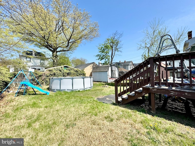 436 Norway Ave, Hamilton, NJ 08629 - view of yard with a storage unit, an outdoor pool, a wooden deck, and an outdoor structure