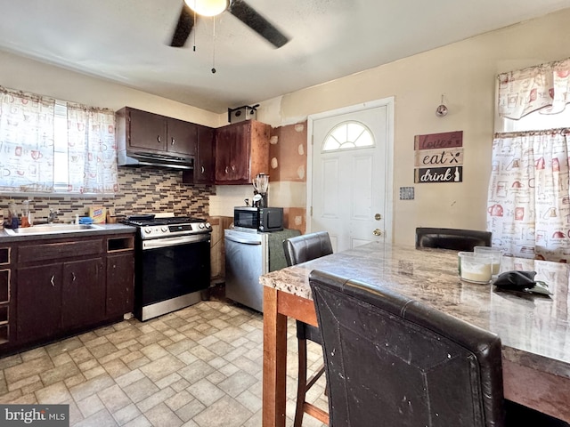 436 Norway Ave, Hamilton, NJ 08629 - kitchen featuring stainless steel gas stove, under cabinet range hood, a sink, black microwave, and a ceiling fan
