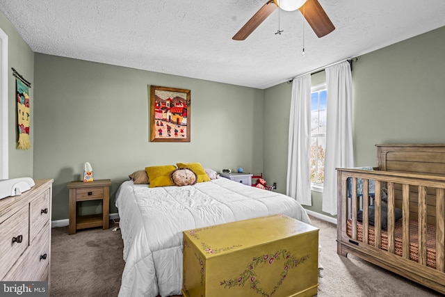 bedroom featuring carpet floors, a ceiling fan, a textured ceiling, and baseboards