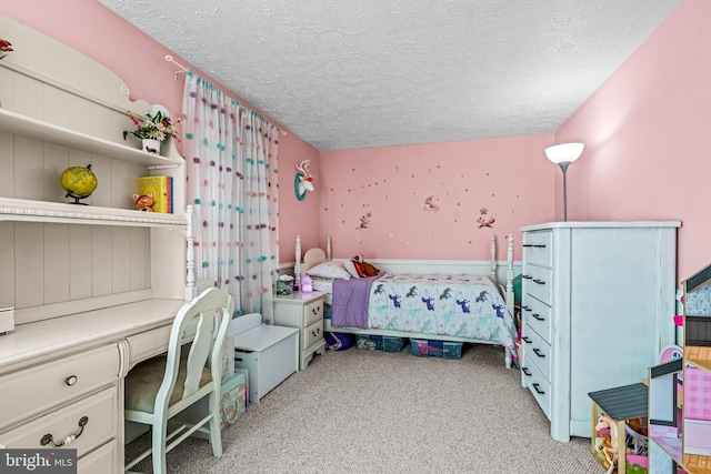 bedroom with a textured ceiling and light colored carpet