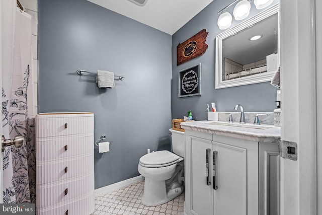 full bathroom with vanity, baseboards, toilet, and tile patterned flooring