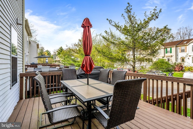 wooden deck featuring outdoor dining area