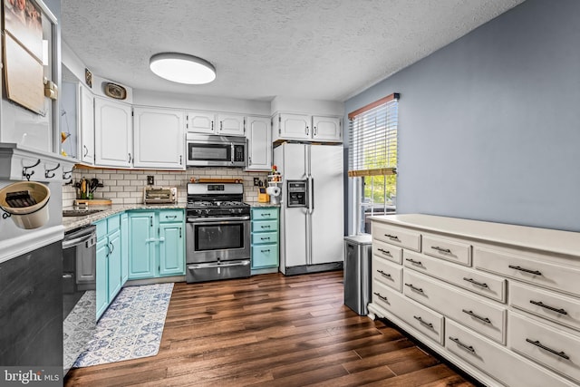 kitchen with dark wood-style floors, white cabinetry, blue cabinets, appliances with stainless steel finishes, and backsplash