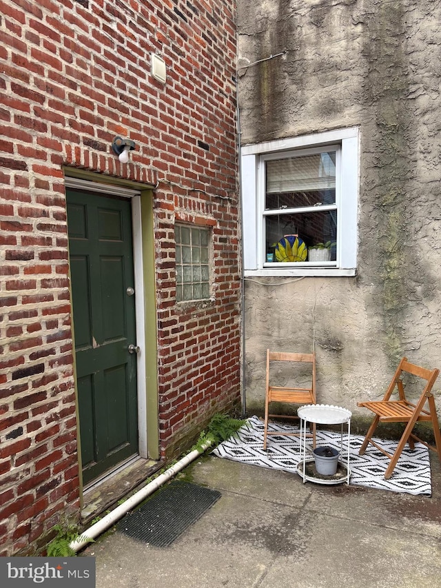 property entrance featuring brick siding