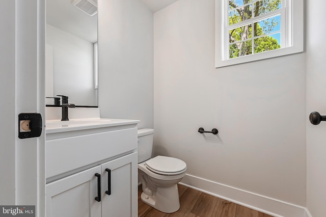 3519 Cedar Dr, Edgewater, MD 21037 - half bathroom with vanity, toilet, baseboards, wood finished floors, and visible vents
