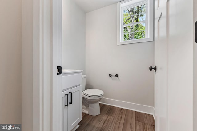 3519 Cedar Dr, Edgewater, MD 21037 - bathroom with vanity, baseboards, toilet, and wood finished floors