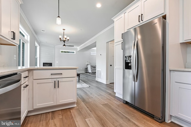 3519 Cedar Dr, Edgewater, MD 21037 - kitchen with appliances with stainless steel finishes, hanging light fixtures, white cabinets, light wood finished floors, and a notable chandelier