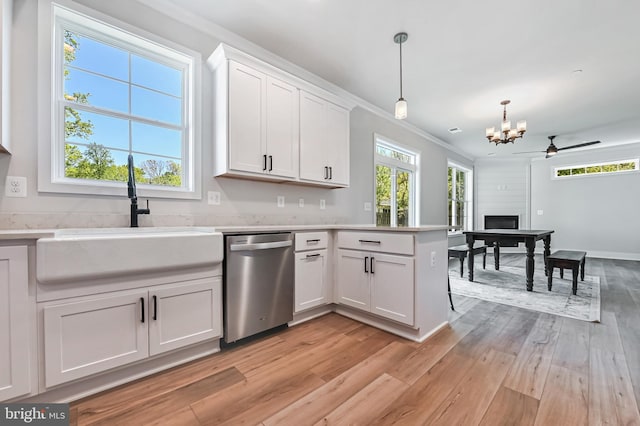 3519 Cedar Dr, Edgewater, MD 21037 - kitchen with dishwasher, a sink, light countertops, light wood finished floors, and an inviting chandelier