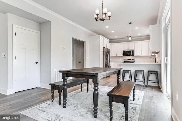 3519 Cedar Dr, Edgewater, MD 21037 - dining area featuring a notable chandelier, visible vents, baseboards, and light wood-style flooring