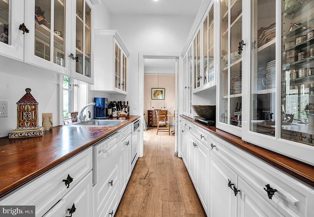 227 Jackson Rd, Cochranville, PA 19330 - kitchen with light wood-type flooring, glass insert cabinets, butcher block countertops, a sink, and white cabinets