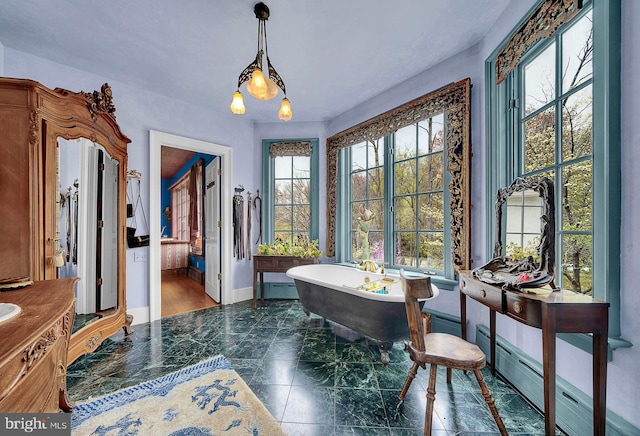 227 Jackson Rd, Cochranville, PA 19330 - dining room with healthy amount of natural light, baseboards, marble tiled floors, and a baseboard heating unit