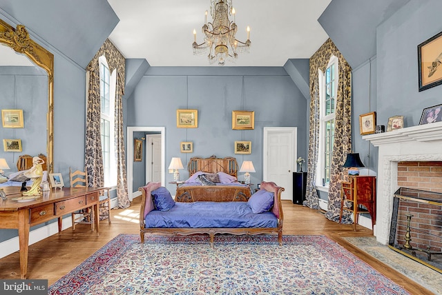 227 Jackson Rd, Cochranville, PA 19330 - bedroom featuring multiple windows, a high ceiling, a chandelier, wood finished floors, and a fireplace