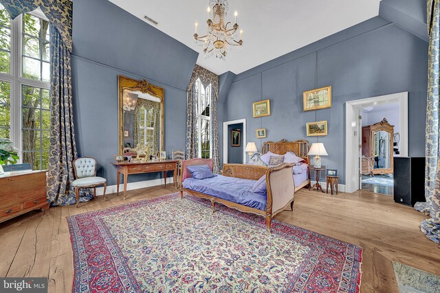 227 Jackson Rd, Cochranville, PA 19330 - bedroom with a chandelier, high vaulted ceiling, and wood-type flooring