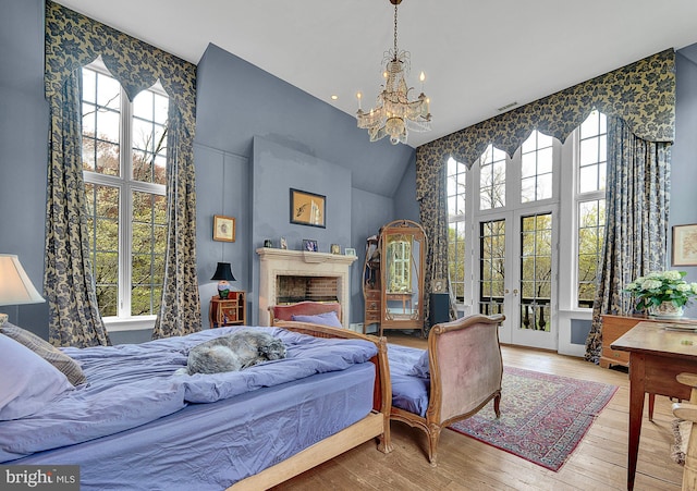 227 Jackson Rd, Cochranville, PA 19330 - bedroom with high vaulted ceiling, multiple windows, a chandelier, french doors, and hardwood / wood-style floors