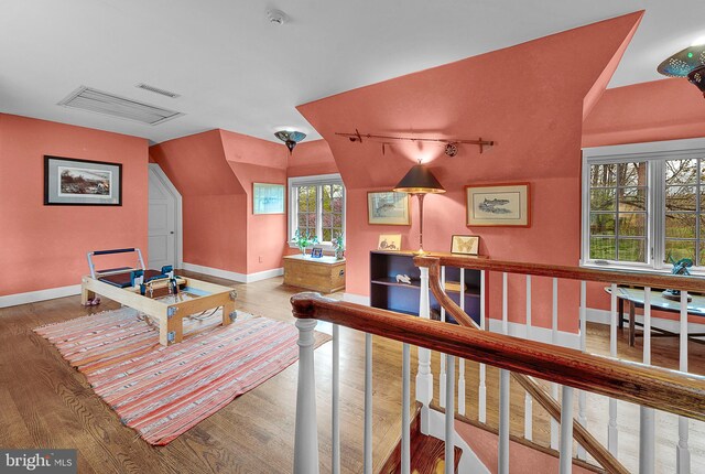 227 Jackson Rd, Cochranville, PA 19330 - sitting room with wood finished floors, baseboards, vaulted ceiling, and an upstairs landing