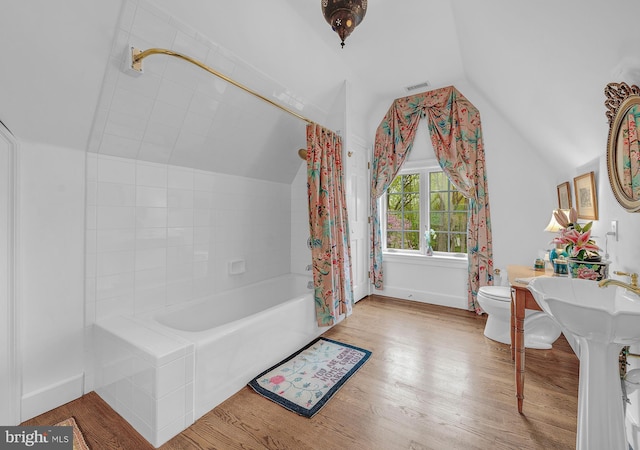 227 Jackson Rd, Cochranville, PA 19330 - full bathroom featuring vaulted ceiling, toilet, wood finished floors, shower / bath combo, and baseboards