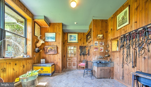 227 Jackson Rd, Cochranville, PA 19330 - misc room with wooden walls, brick patterned floors, and healthy amount of natural light