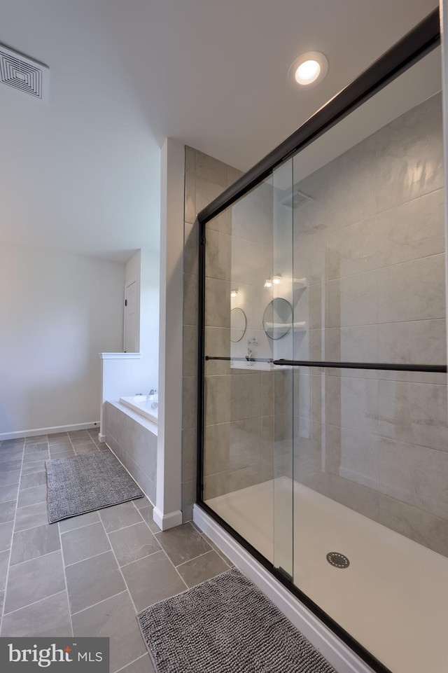 full bathroom with visible vents, tile patterned flooring, a garden tub, and a shower stall