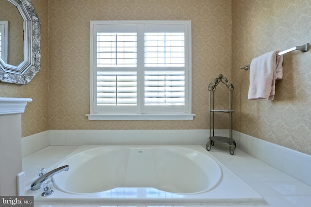 bathroom featuring a bath and wallpapered walls