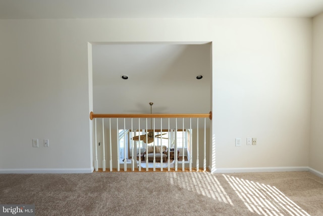 interior space featuring baseboards, a towering ceiling, and carpet