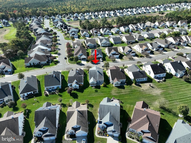 bird's eye view featuring a forest view and a residential view