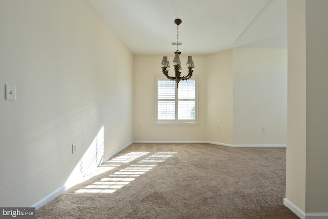 carpeted spare room featuring baseboards, visible vents, and an inviting chandelier