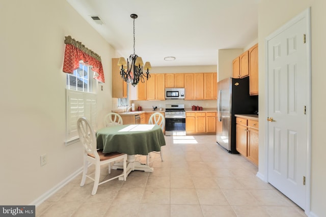 dining area with baseboards, visible vents, a notable chandelier, and light tile patterned flooring