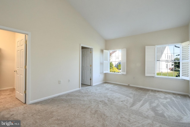 unfurnished bedroom with high vaulted ceiling, baseboards, and carpet flooring