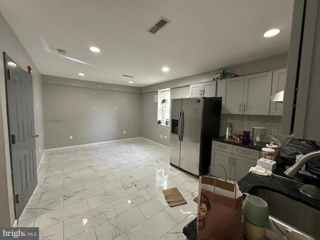 2108 Ridge Ave, Philadelphia, PA 19121 - kitchen with marble finish floor, dark countertops, visible vents, a sink, and stainless steel refrigerator with ice dispenser