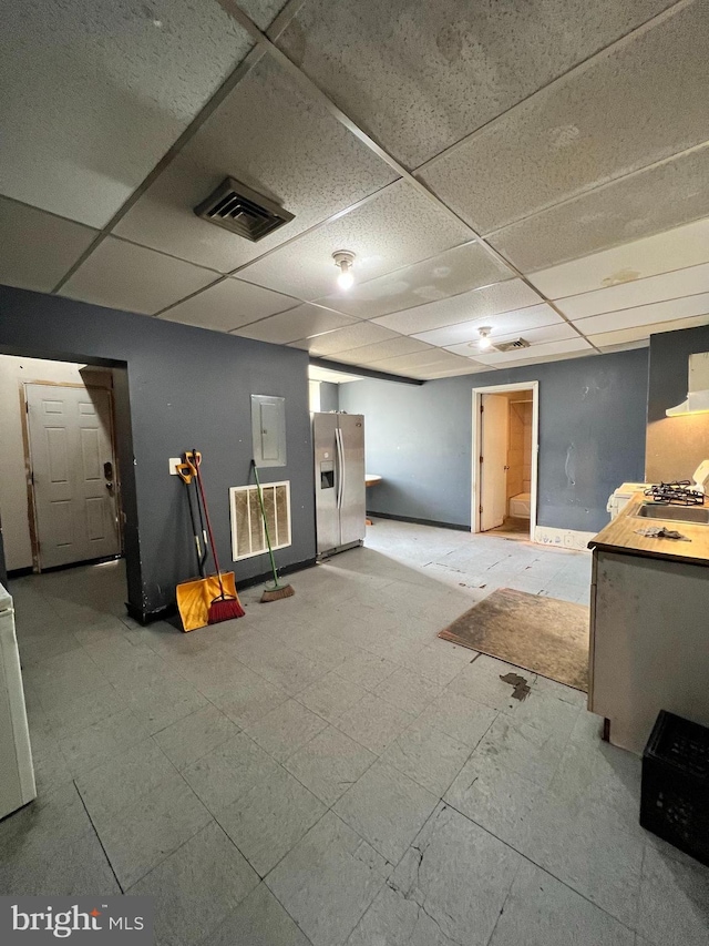 3038 W 2nd St, Chester, PA 19013 - finished below grade area featuring visible vents, a paneled ceiling, baseboards, and stainless steel fridge with ice dispenser