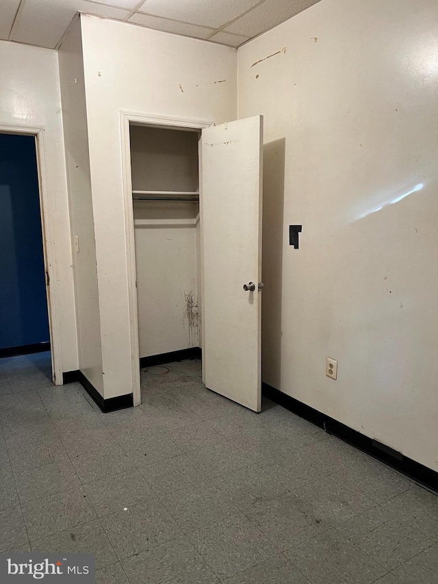 3038 W 2nd St, Chester, PA 19013 - unfurnished bedroom with baseboards, a paneled ceiling, tile patterned floors, and a closet