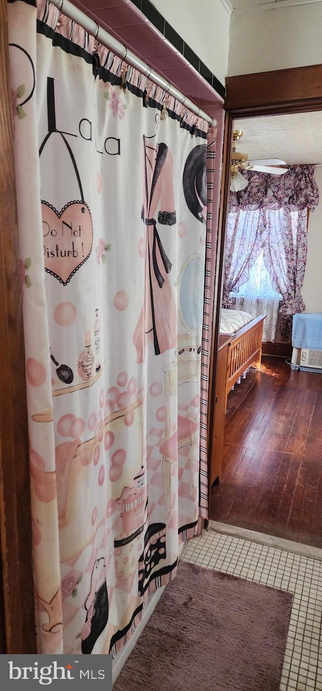 full bathroom featuring hardwood / wood-style flooring and a shower with shower curtain