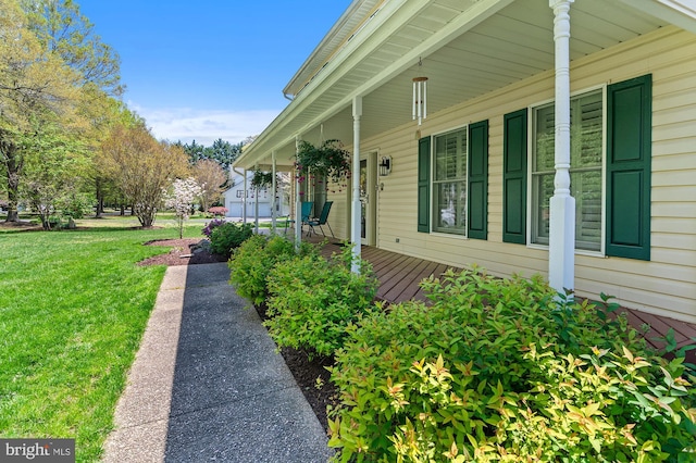 view of home's exterior featuring a porch and a yard