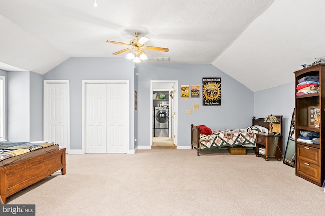 carpeted bedroom featuring ceiling fan, visible vents, multiple closets, baseboards, and vaulted ceiling