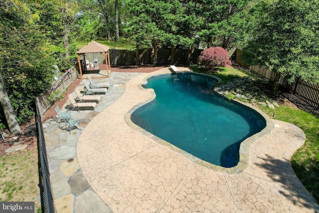 view of swimming pool featuring a fenced backyard, a fenced in pool, a gazebo, and a patio area