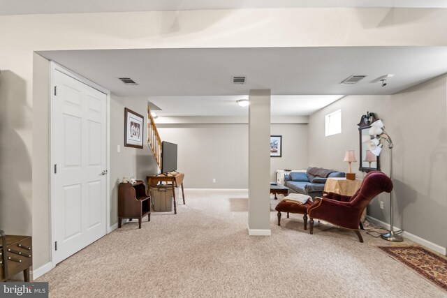 living area featuring visible vents, baseboards, stairs, and light carpet