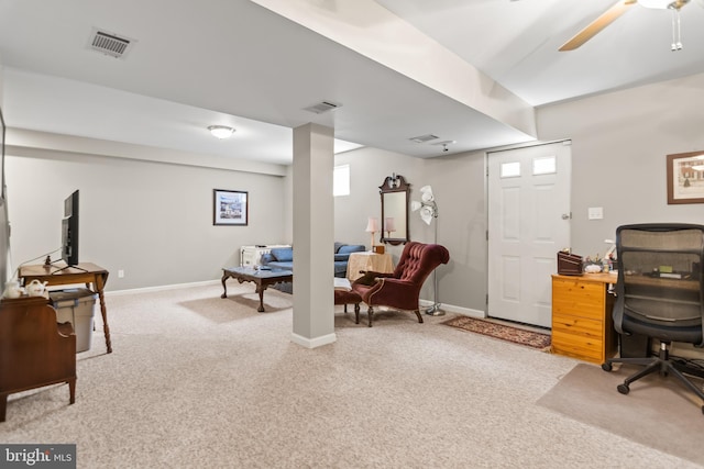 office space with baseboards, light carpet, a ceiling fan, and visible vents