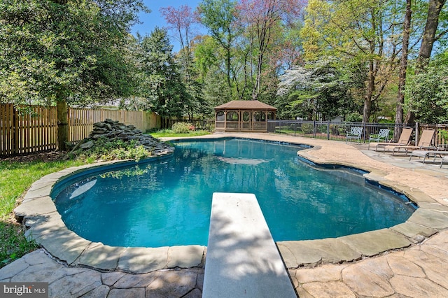 view of swimming pool featuring a diving board, a gazebo, a fenced in pool, a fenced backyard, and a patio
