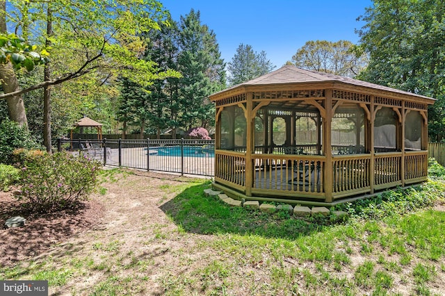 view of swimming pool with fence, a gazebo, and a fenced in pool