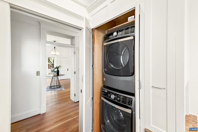 410 Altamont Cir, Charlottesville, VA 22902 - washroom with stacked washer and clothes dryer, baseboards, light wood finished floors, a notable chandelier, and laundry area