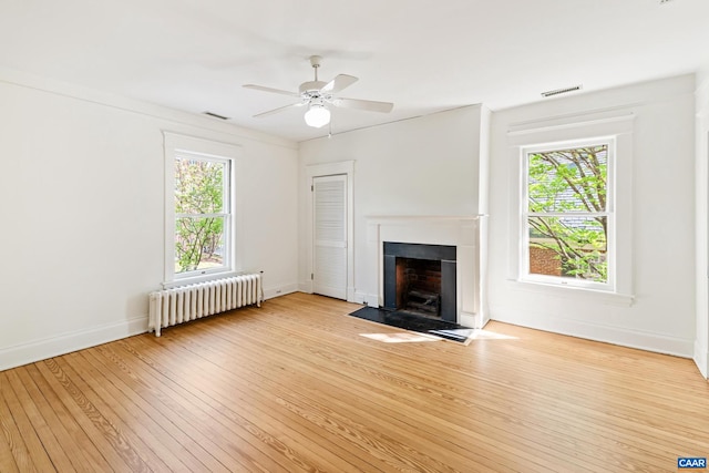 410 Altamont Cir, Charlottesville, VA 22902 - unfurnished living room with radiator, a ceiling fan, visible vents, and light wood-style flooring
